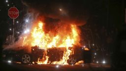 A car burns after petrol bombs were thrown at police in the Creggan area of Londonderry, in Northern Ireland, Thursday, April 18, 2019. (Niall Carson/PA via AP)
