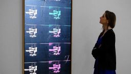 A member of the auction house staff poses with "Fourteen Small Electric Chairs" by Andy Warhol (est. £4,000,000-6,000,000) during a photocall on February 1, 2016 to promote Bonham's upcoming "Post-War and Contemporary Art" sale in London.

The sale takes place on February 11 with items by artists including Kazuo Shiraga, Frank Auerbach and Germaine Richier.  / AFP / LEON NEAL / RESTRICTED TO EDITORIAL USE - MANDATORY MENTION OF THE ARTIST UPON PUBLICATION - TO ILLUSTRATE THE EVENT AS SPECIFIED IN THE CAPTION        (Photo credit should read LEON NEAL/AFP/Getty Images)