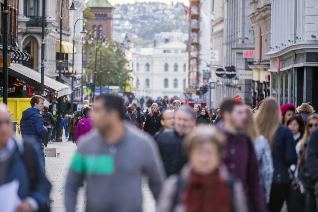 Pedestrians walk along a shopping street in central Oslo. Norway has not only profited enormously from extracting its oil and gas resources, it also may have benefited from global warming that resulted from it, a new study finds.