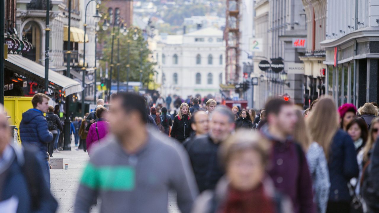 Pedestrians walk along a shopping street in central Oslo. Norway has not only profited enormously from extracting its oil and gas resources, it also may have benefited from global warming that resulted from it, a new study finds.