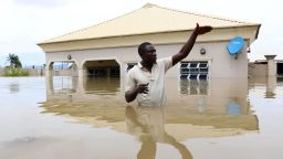 TOPSHOT - A man gestures next to his flooded house following heavy rain near the Nigerian town of Lokoja, in Kogi State, on September 14, 2018. (Photo by Sodiq ADELAKUN / AFP)        (Photo credit should read SODIQ ADELAKUN/AFP/Getty Images)