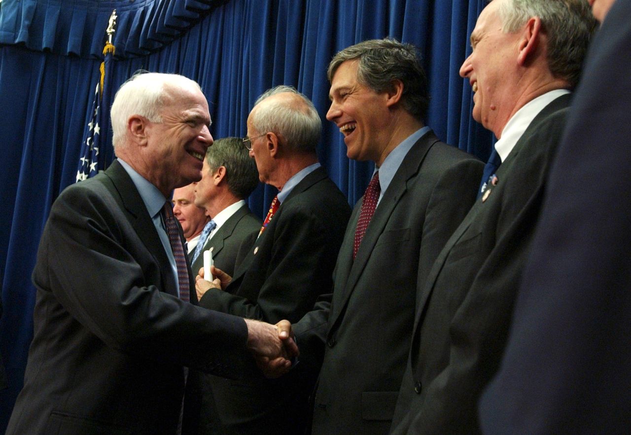 US Sen. John McCain shakes Inslee's hand in 2004 after a bipartisan news conference in support of the Climate Stewardship Acts, which aimed to enact the first nationwide restrictions on greenhouse gas emissions.