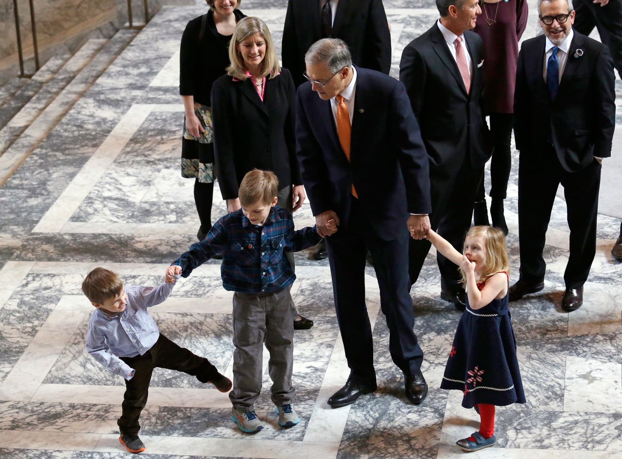 Inslee walks with some of his grandchildren before heading into a joint session of the state legislature in 2017.