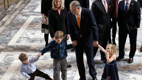 Inslee walks with some of his grandchildren before heading into a joint session of the state legislature in 2017.