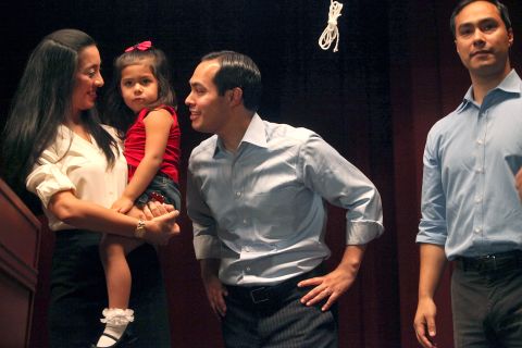 Castro, center, is joined on stage with his wife, Erica, and their daughter, Carina, at an event in September 2012. Castro's brother, Joaquin, is at right.