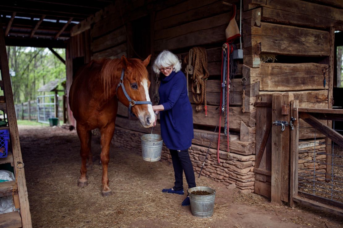 Taylor feeds her horse Billy. The horses, chickens and dogs on her farm are reoccurring characters in many of her stories.