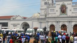 Ambulances are seen outside the church premises with gathered people and security personnel following a blast at the St. Anthony's Shrine in Kochchikade, Colombo on April 21, 2019. - Explosions have hit three churches and three hotels in and around the Sri Lankan capital of Colombo, police said on April 21. (Photo by ISHARA S.  KODIKARA / AFP)        (Photo credit should read ISHARA S.  KODIKARA/AFP/Getty Images)