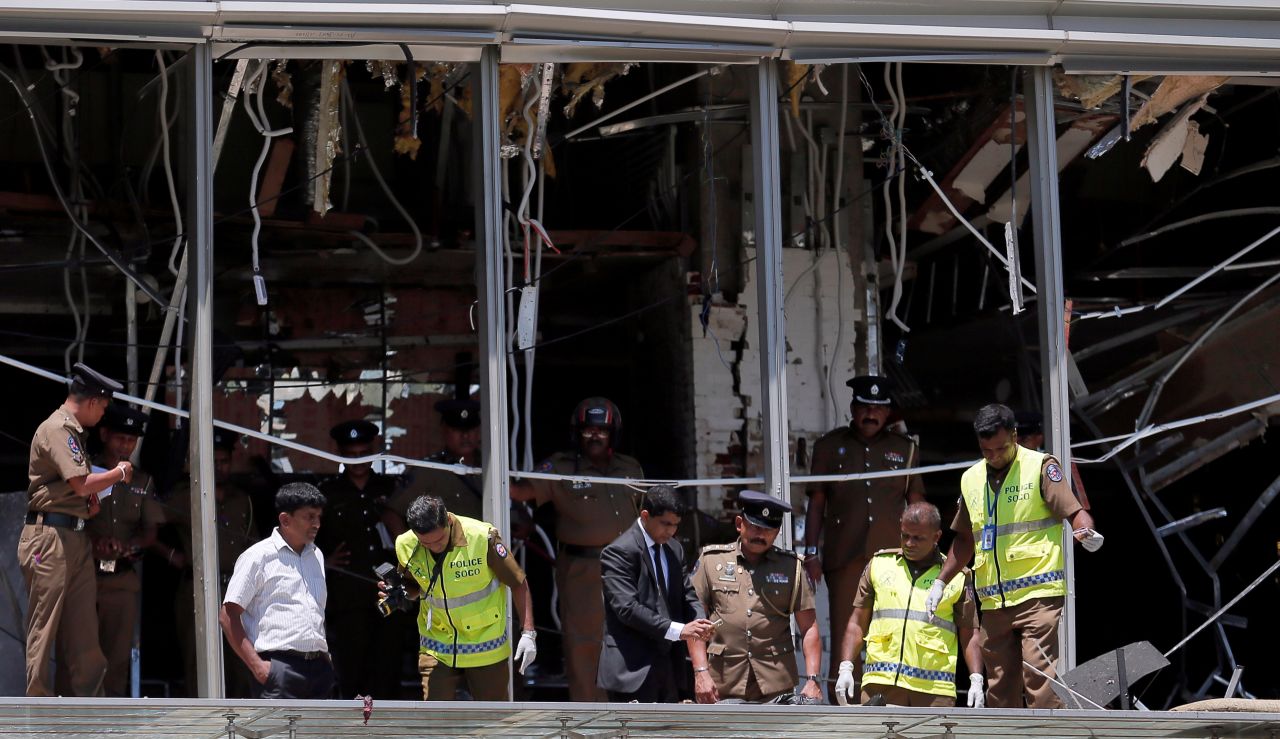 Crime scene investigators inspect the scene of an explosion at the Shangri-La hotel in Colombo.