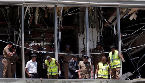 Crime scene investigators inspect the scene of an explosion at the Shangri-La hotel in Colombo.