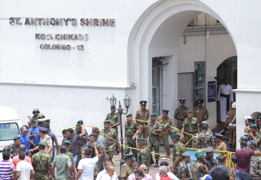 Sri Lankan military officers stand guard in front of St. Anthony's Shrine.
