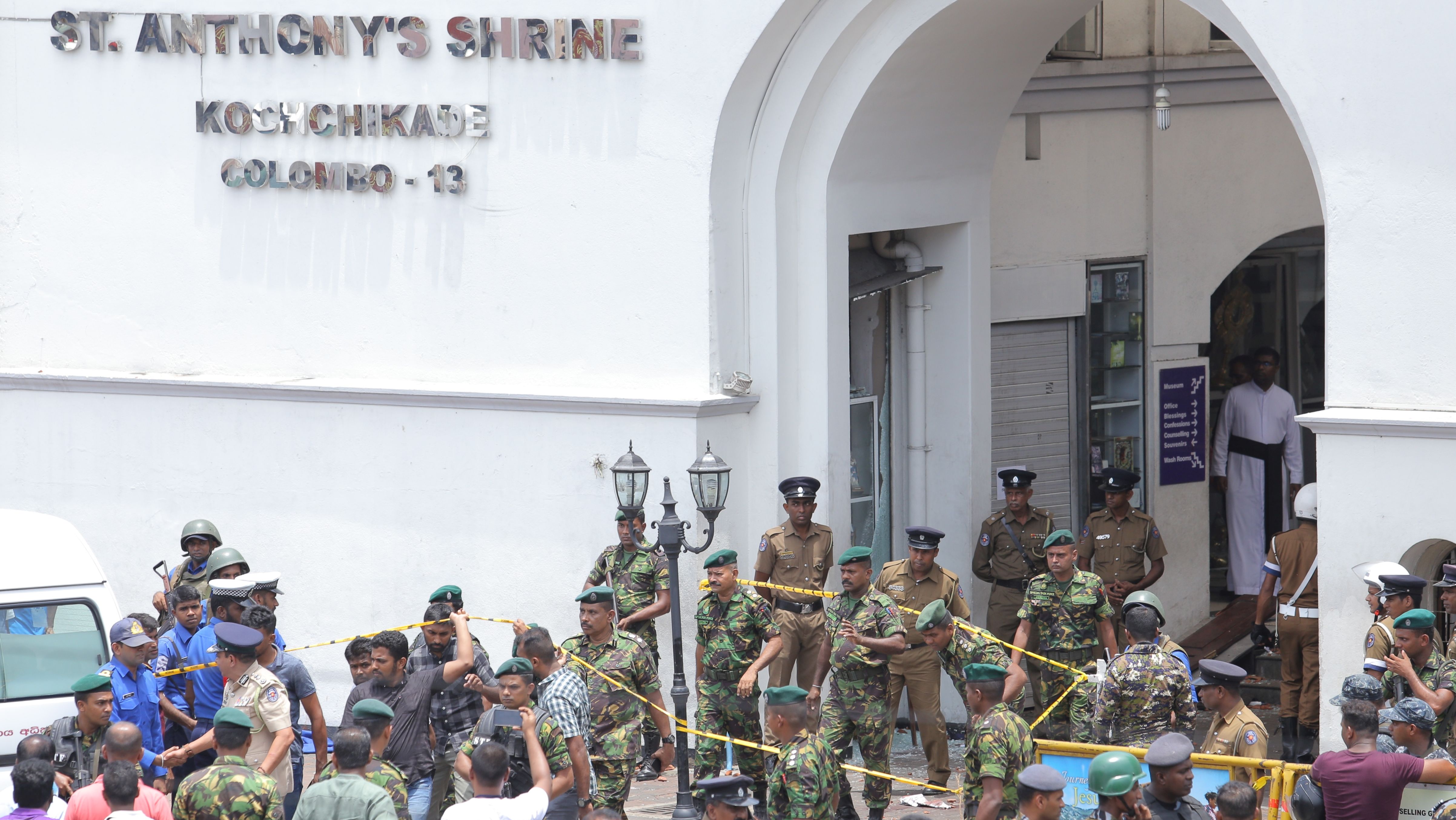 Sri Lankan military officers stand guard in front of St. Anthony's Shrine.