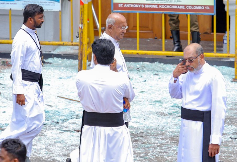 Priests view blast debris outside St. Anthony's Shrine.