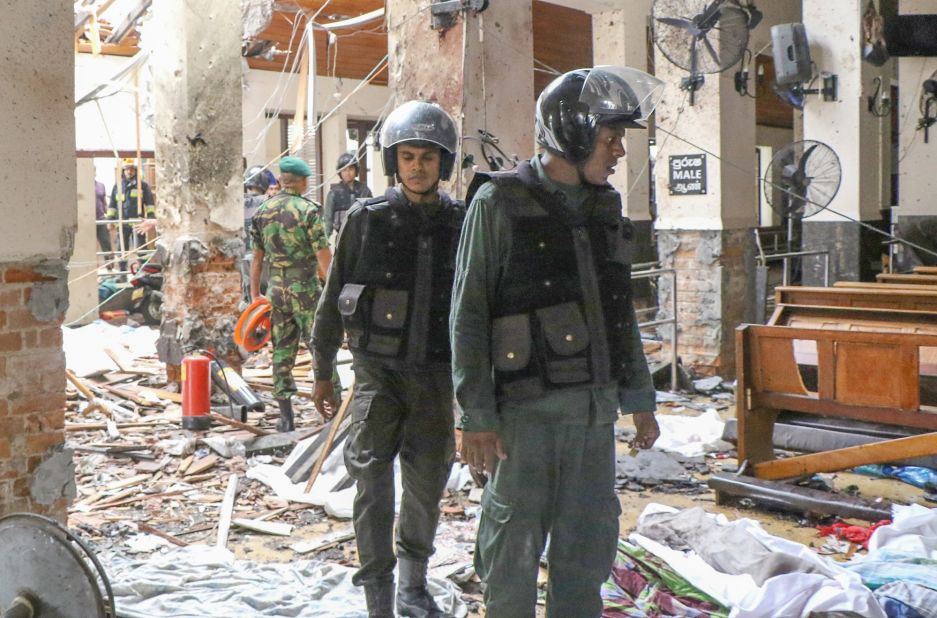 Security forces inspect the inside of St. Anthony's Shrine after Sunday's attack.