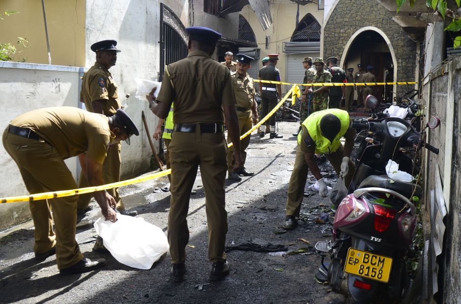 Security personnel and investigators sift through debris outside Zion Church in Batticaloa.