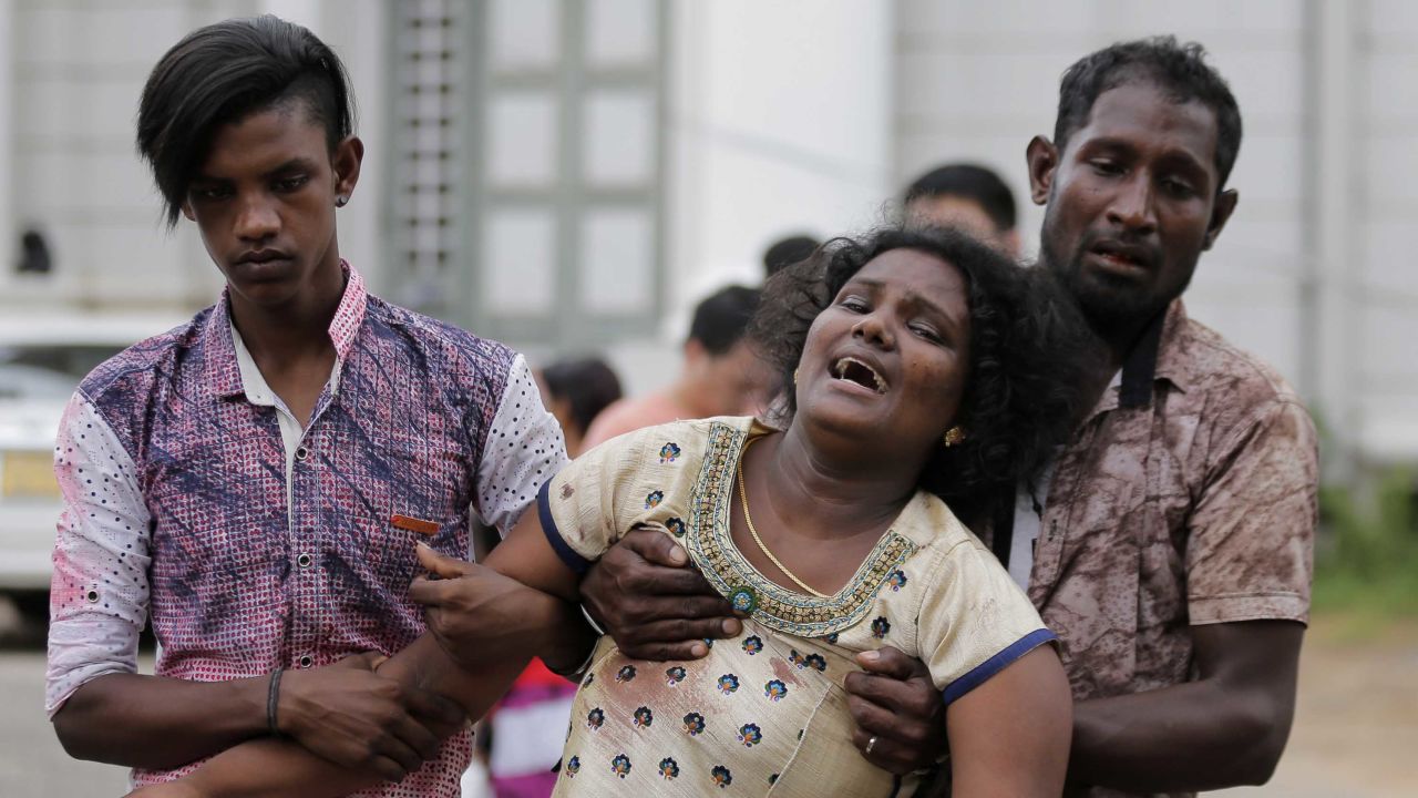 Relatives of a blast victim grieve outside a morgue in Colombo.