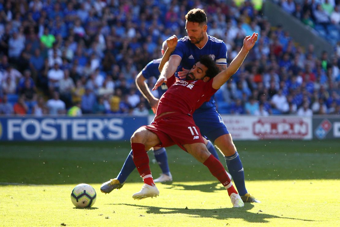 Mohamed Salah is hauled to the ground by Sean Morrison for a Liverpool penalty.