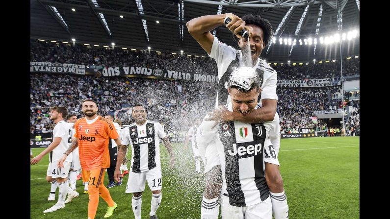 Cristiano Ronaldo celebrates with Juan Cuadrado after winning the Italian championship Serie A match between Juventus and ACF Fiorentina on Saturday, April 20, in Turin, Italy. The win makes Ronaldo the <a href="index.php?page=&url=https%3A%2F%2Fwww.cnn.com%2F2019%2F04%2F20%2Ffootball%2Fjuventus-champions-serie-a-cristiano-ronaldo-spt-intl%2Findex.html" target="_blank">first player to win</a> the Premier League, La Liga and Serie A.