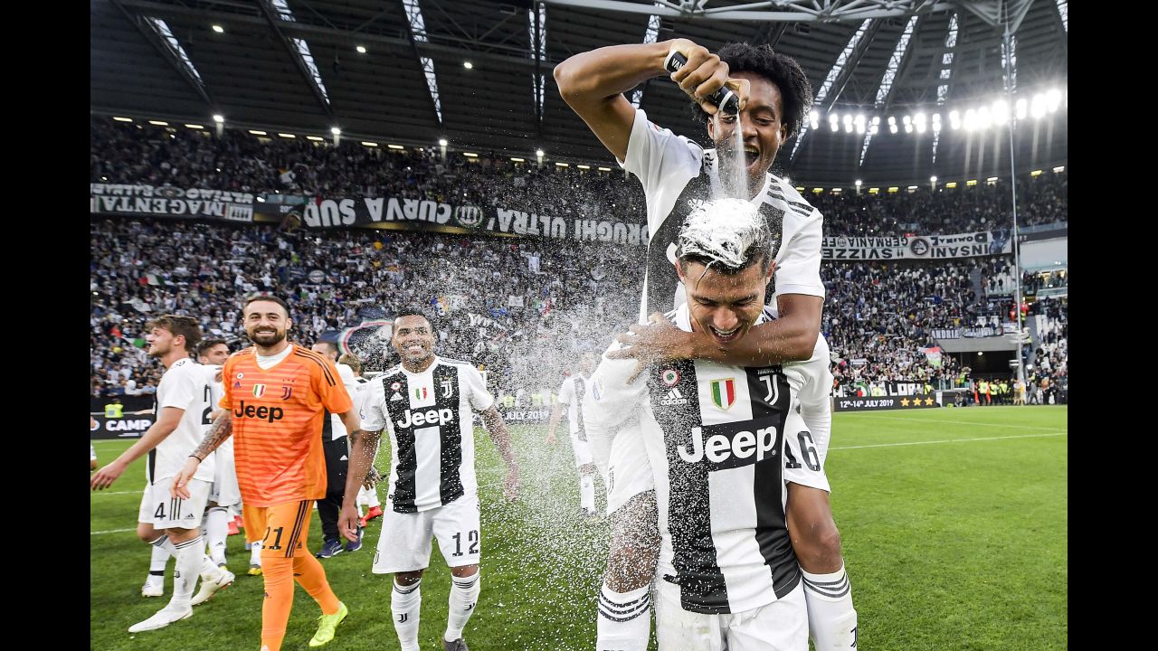 Cristiano Ronaldo celebrates with Juan Cuadrado after winning the Italian championship Serie A match between Juventus and ACF Fiorentina on Saturday, April 20, in Turin, Italy. The win makes Ronaldo the <a href="https://www.cnn.com/2019/04/20/football/juventus-champions-serie-a-cristiano-ronaldo-spt-intl/index.html" target="_blank">first player to win</a> the Premier League, La Liga and Serie A.