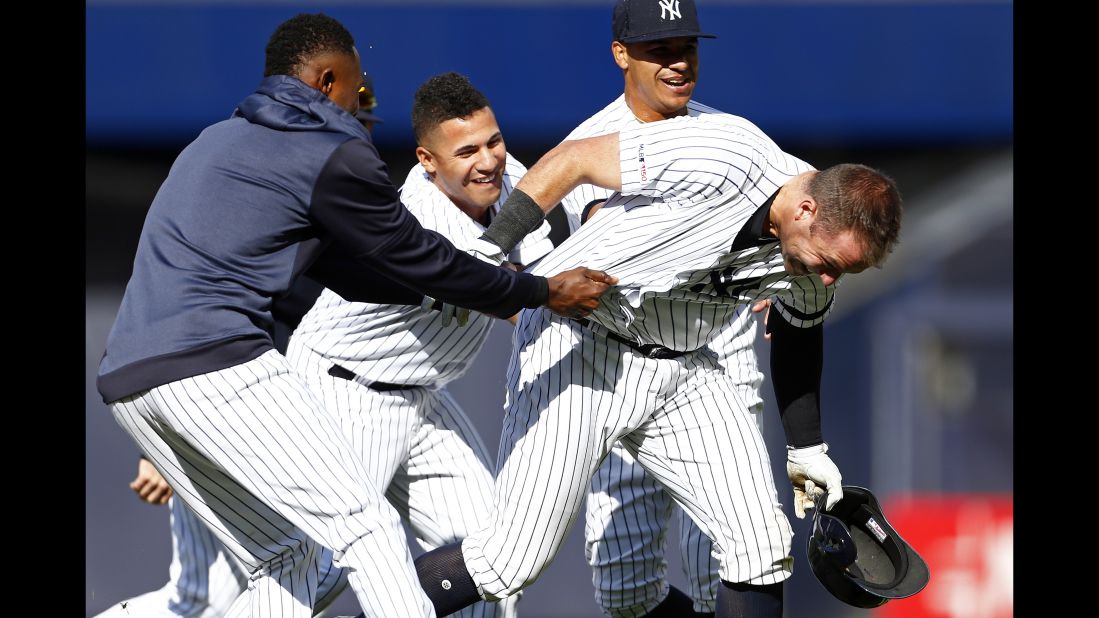 New York Yankees' Austin Romine, right, is congratulated by teammates after hitting a walk off single in the 10th inning against the Kansas City Royals on Sunday, April 21, in New York.