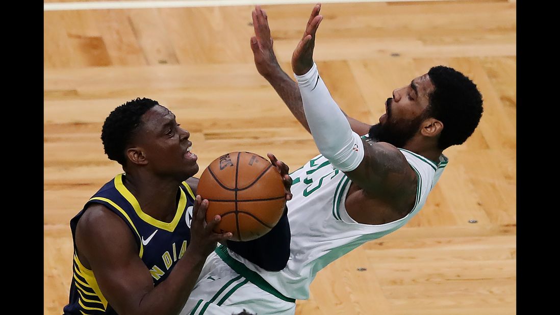 Darren Collison of the Indiana Pacers, left, charges into Kyrie Irving of the Boston Celtics during the first quarter on Wednesday, April 17, in Boston.