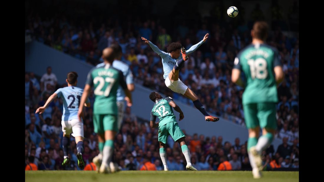 Manchester City's Leroy Sane jumps for the ball over Tottenham Hotspur's Victor Wanyama during the English Premier League football match on Saturday, April 20, in Manchester.