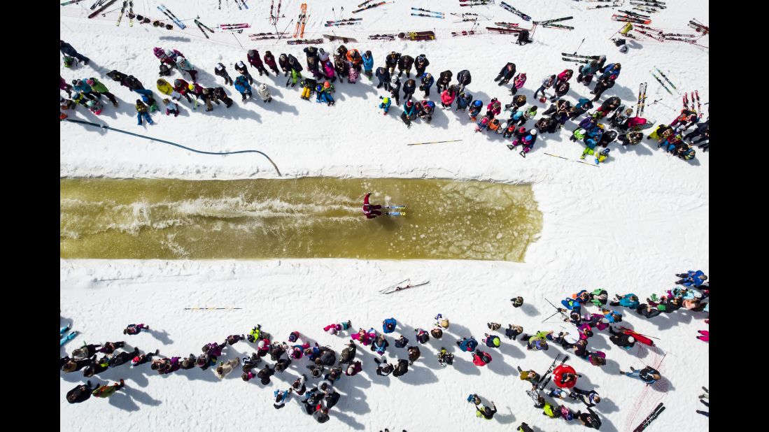 A skier glides over a pool of a water during a waterslide contest at the Nendaz ski resort in Switzerland on Saturday, April 20.