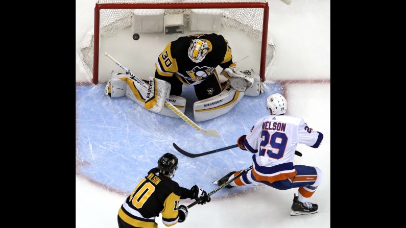 Brock Nelson of the New York Islanders scores on Pittsburgh Penguins goaltender Matt Murray during the first period of Game 4 of their NHL first-round playoff series in Pittsburgh on Tuesday, April 16. The <a href="index.php?page=&url=https%3A%2F%2Fbleacherreport.com%2Farticles%2F2831685-islanders-complete-series-sweep-of-sidney-crosby-penguins-with-3-1-game-4-win" target="_blank" target="_blank">Islanders won the game 3-1</a>, sweeping the Penguins to advance to the second round.