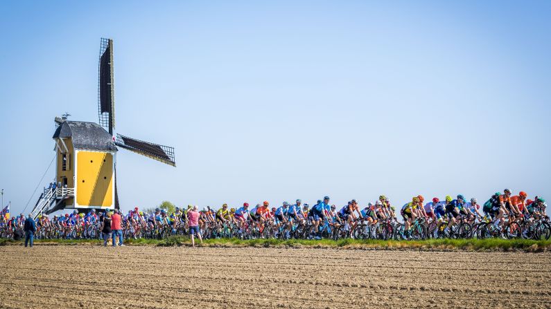 Cyclists ride past a windmill in Maastricht, Netherlands, during the Amstel Gold Cycling Race on Sunday, April 21.