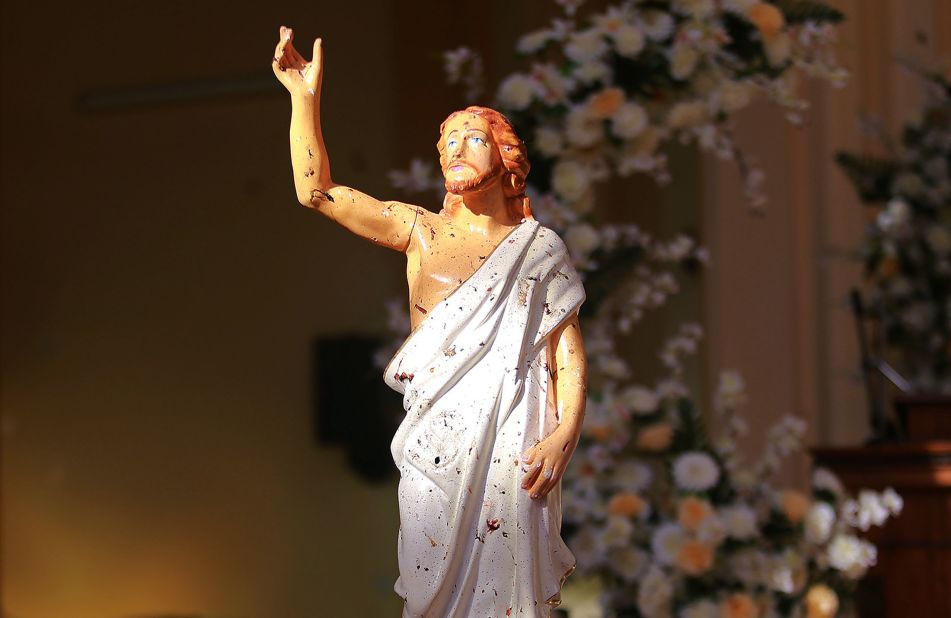 Blood stains are seen on a statue of Jesus Christ after a bomb blast inside a church in Negombo, on Sunday.