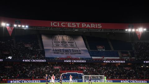 PSG fans hold aloft a banner showing a drawing of Notre-Dame with the Paris city motto: "Fluctuat Nec Mergitur" ("She is tossed but not sunk")