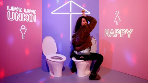A visitor poses for her photo on a display toilet at the the Unko ("poop" in Japanese) museum in Yokohama, Japan, April 17, 2019. REUTERS/Kim Kyung-hoon