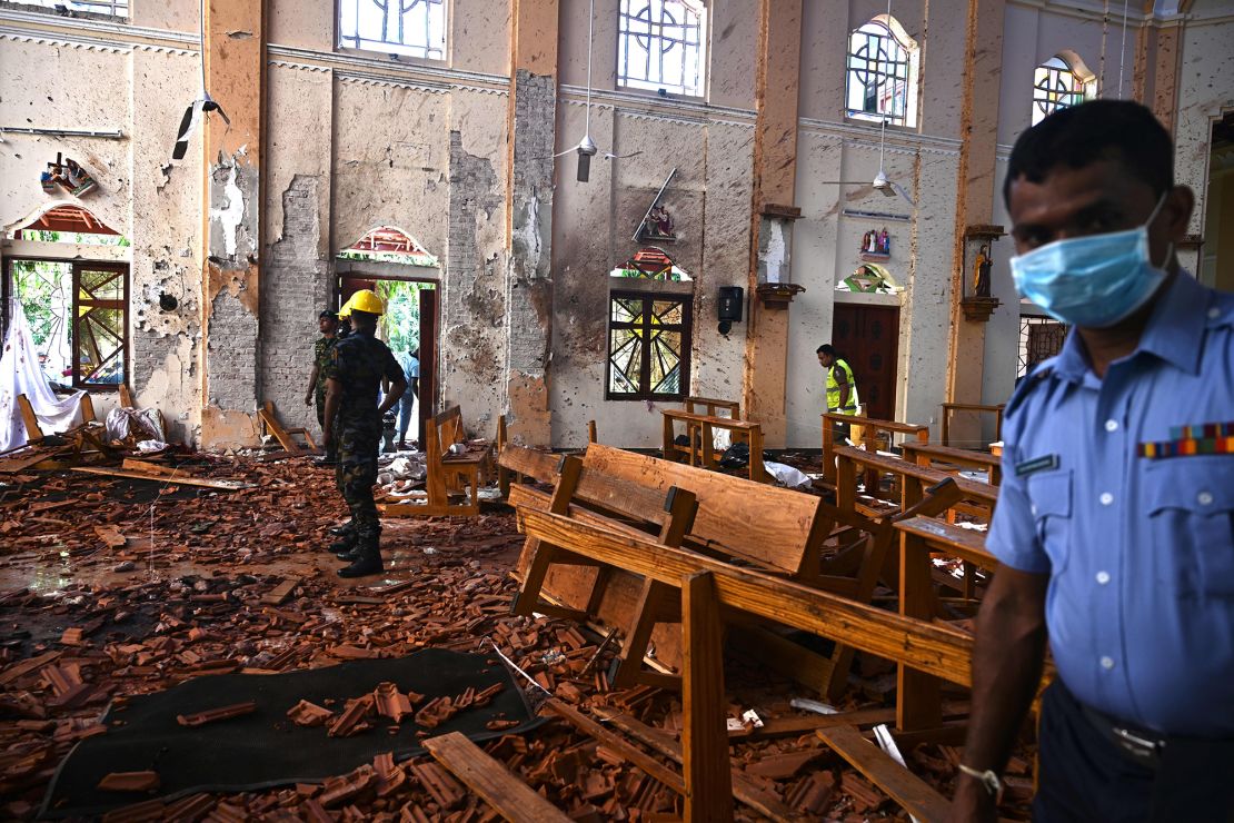 Security personnel inspect the interior of St Sebastian's Church in Negombo on April 22, 2019, a day after the church was hit in series of bomb blasts.