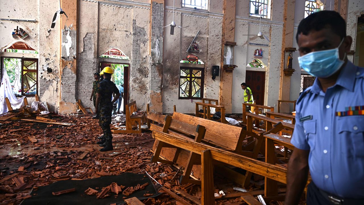 Security personnel inspect the interior of St Sebastian's Church in Negombo on April 22, 2019, a day after the church was hit in series of bomb blasts.