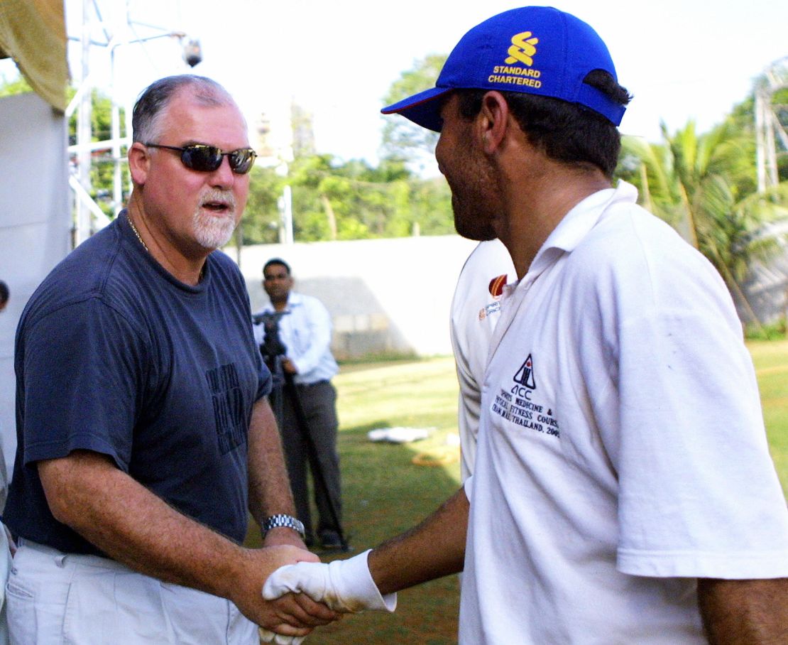 Gatting (left) shakes hands with a member of the Afghan team after their match in 2006. The former England captain was dismissed for a duck.