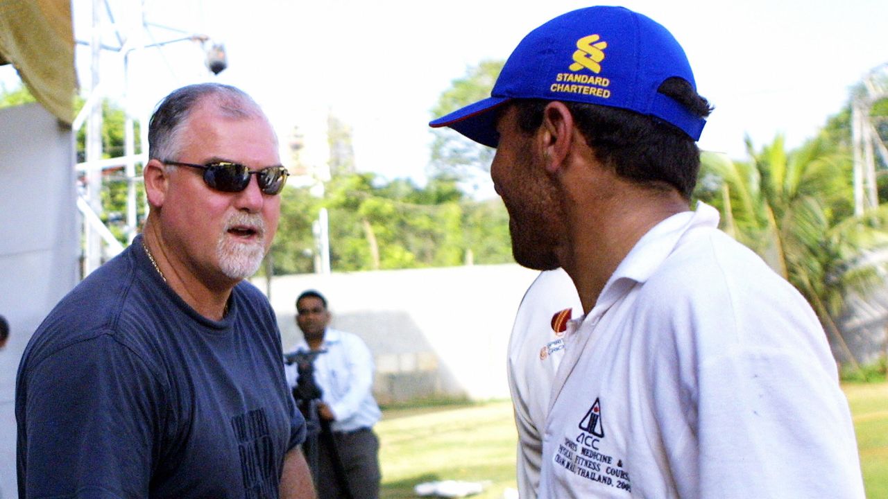 Gatting (left) shakes hands with a member of the Afghan team after their match in 2006. The former England captain was dismissed for a duck.