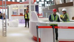 Workers are seen at the booth of ExxonMobil in preparation ahead of the International Conference & Exhibition on Liquefied Natural Gas (LNG2019) in Shanghai, China April 1, 2019. REUTERS/Stringer ATTENTION EDITORS - THIS IMAGE WAS PROVIDED BY A THIRD PARTY. CHINA OUT.