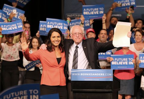 Gabbard and Democratic presidential candidate Bernie Sanders wave to supporters during a campaign event in Miami in March 2016. Gabbard left the Democratic National Committee to endorse Sanders' presidential bid.