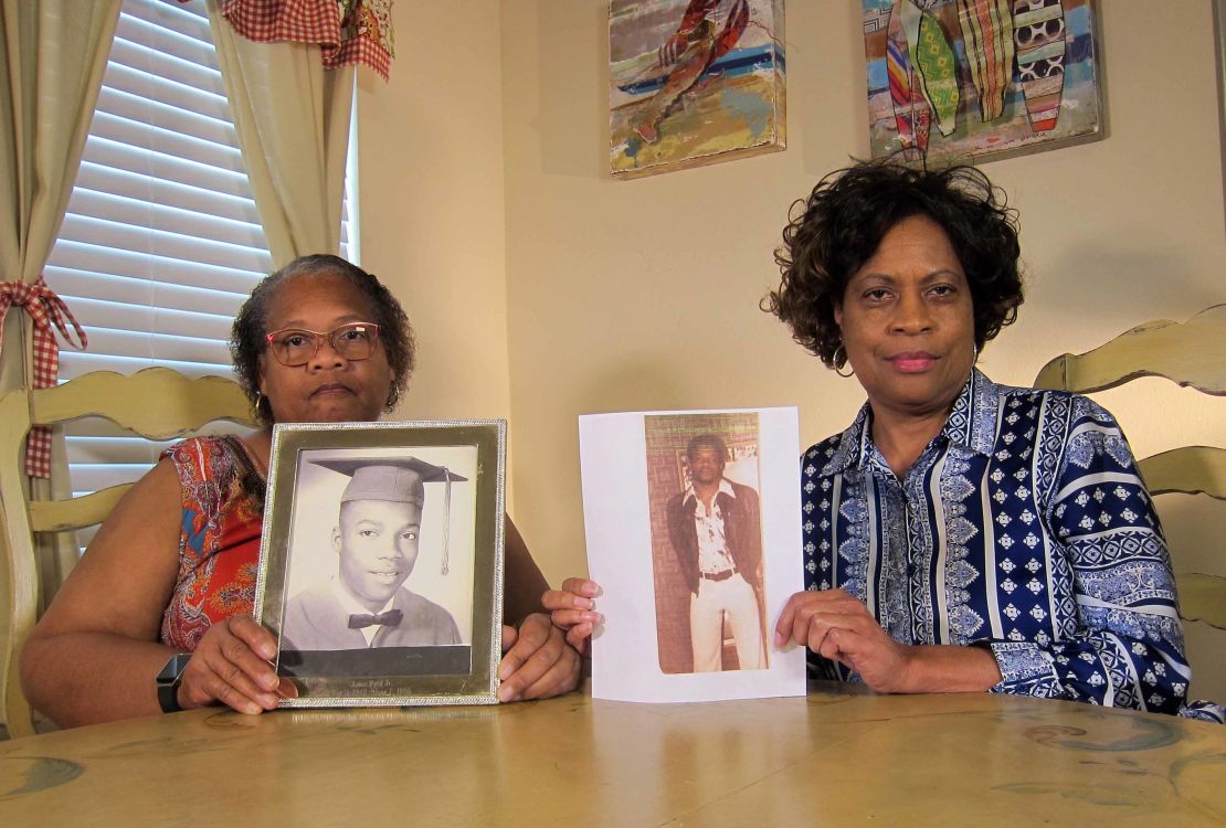 Louvon Byrd, left, and Mylinda Byrd Washington display photos of their late brother earlier this month. 