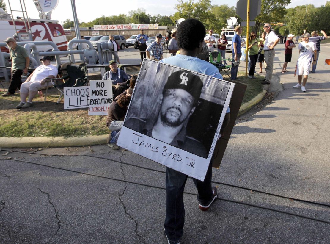 Ricky Jason, a friend of Ross Byrd's, wears a photo of James Byrd before Russell Brewer's execution.