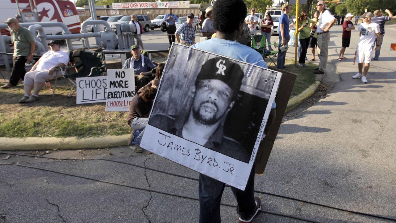 Ricky Jason, a friend of Ross Byrd's, wears a photo of James Byrd before Russell Brewer's execution.