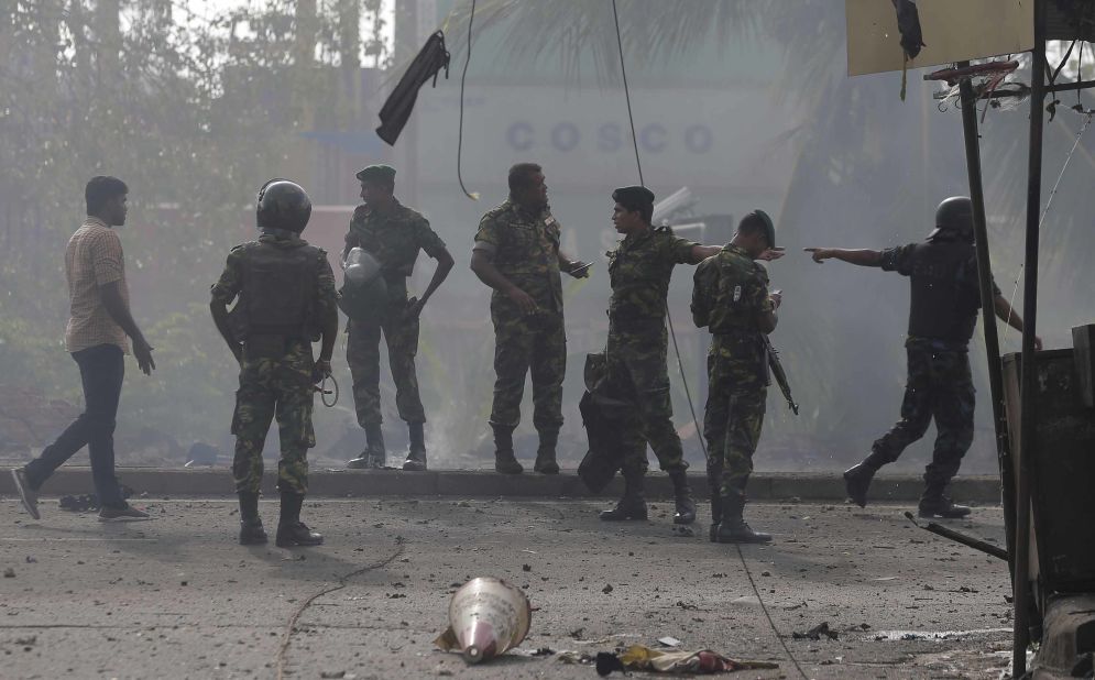 Sri Lankan security forces stand at the site near St. Anthony's shrine in Colombo after they performed a controlled detonation of a suspicious van on Monday.