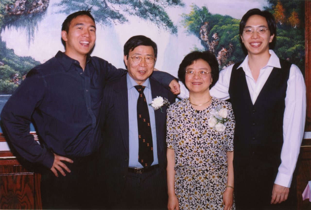 Yang, left, poses with his parents and brother. He studied economics and political science at Brown University and went to law school at Columbia University.