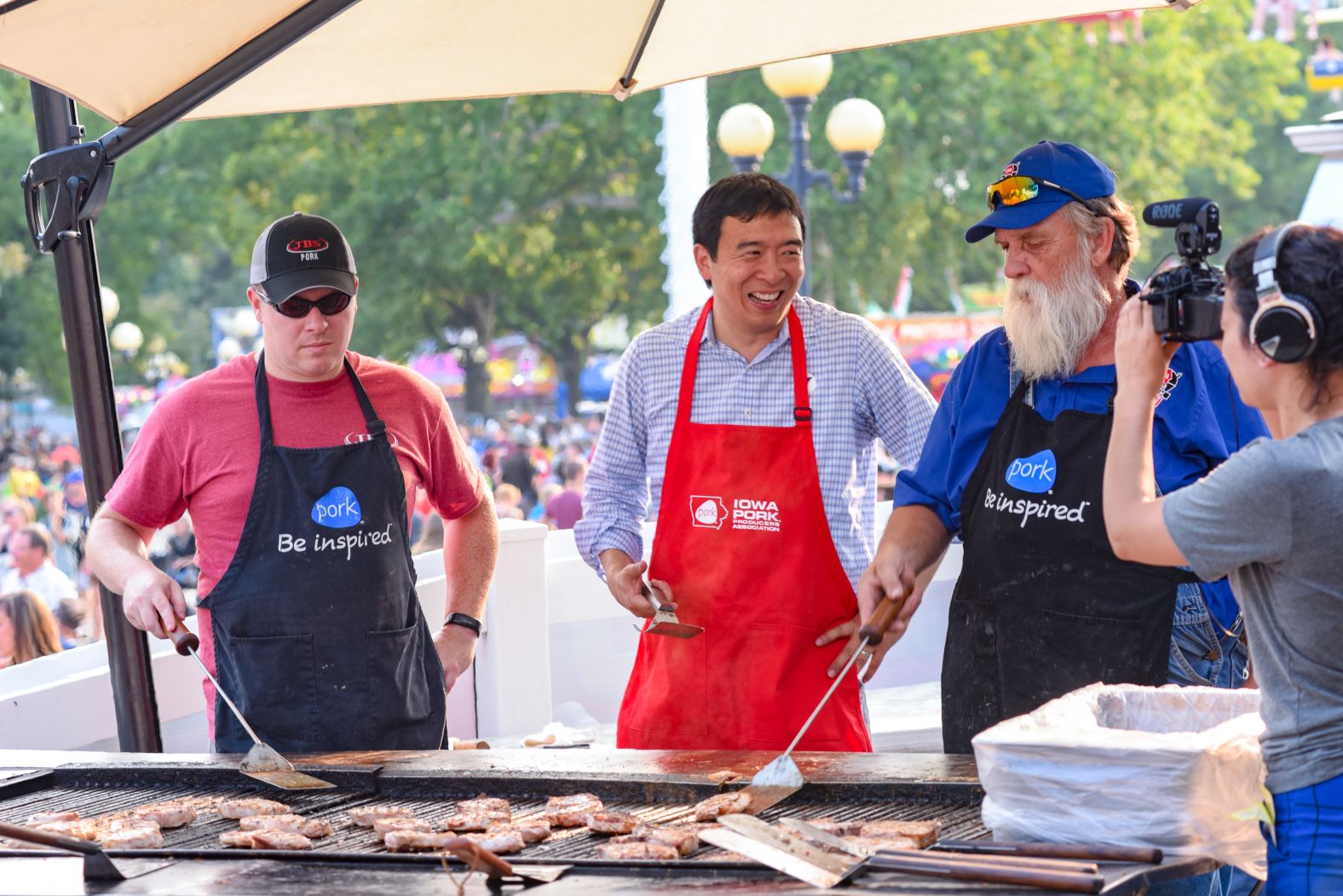 Yang helps man the grill at the Iowa State Fair.