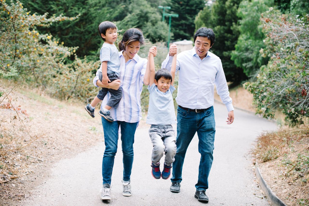Yang and his wife, Evelyn, walk with their two sons.