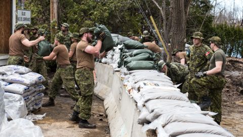 Members of the Canadian Army prepare flooding defenses in Laval, Quebec, where water was at a dangerous level on Sunday.