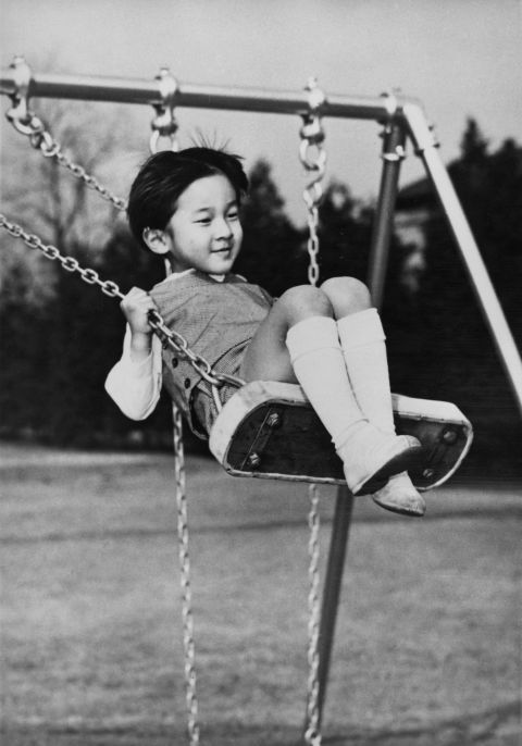 Naruhito plays on a swing on his fifth birthday in February 1965.