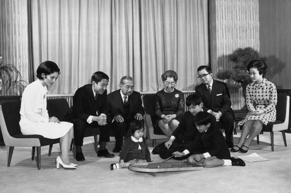 Naruhito, front middle, plays a pinball game with his two siblings -- Sayako, left, and Fumihito -- in 1972. Watching them, from left, are their parents, Michiko and Akihito; their grandparents, Emperor Hirohito and Empress Nagako; their uncle Masahito; and their aunt Hanako.