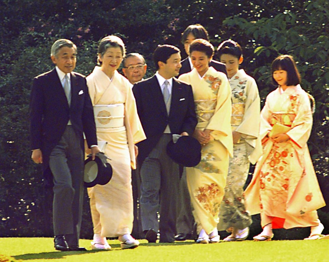 Emperor Akihito and Empress Michiko, left, lead their two sons, accompanied by their spouses, and a daughter during the annual autumn imperial garden party at Akasaka Palace in Tokyo in 1997.