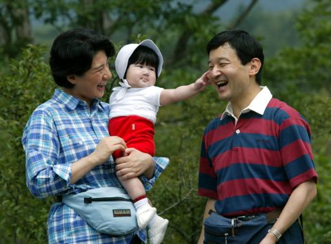 Naruhito and Masako walk with their daughter, Aiko, during a family outing in August 2002. Aiko is their only child.