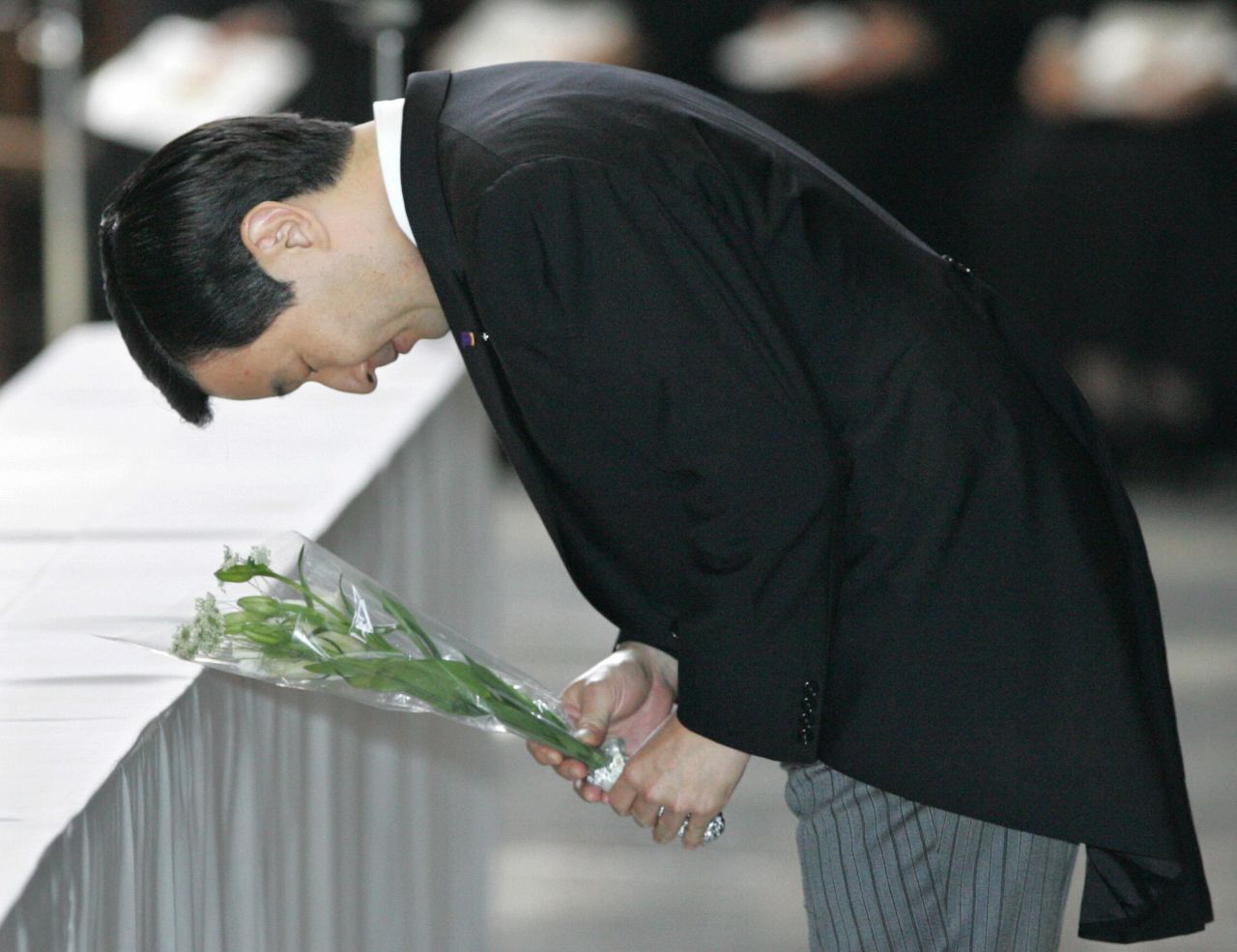 Naruhito pays his respects to the late Pope John Paul II during a memorial service in Tokyo in April 2005.